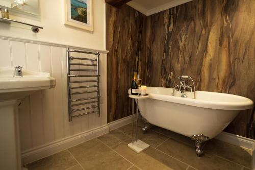 a bathroom with a tub and a sink at The Old Mill House in Padstow