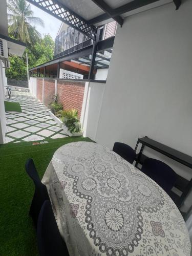 a patio with a table and chairs on a balcony at Kj Resident Homestay in Alor Setar