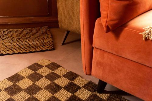 a living room with a couch and a rug at Maison Rokxy - Luxury Apartments in London