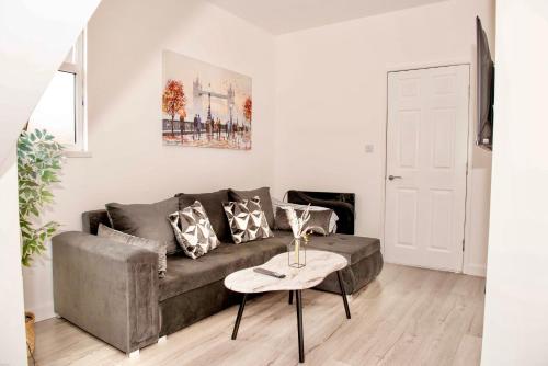a living room with a couch and a table at 2 Bedroom Apartment Southsea - Sleeps 5 & Free Parking in Portsmouth