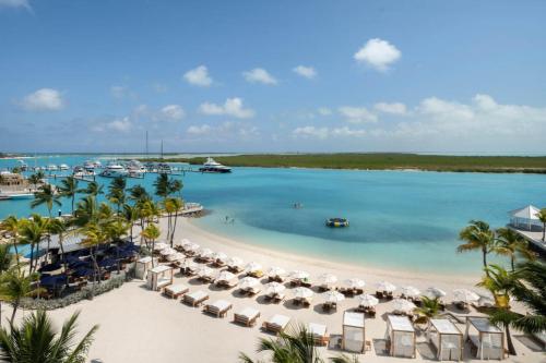 an aerial view of a beach with chairs and umbrellas at Blue Haven Resort- All Inclusive in Grace Bay