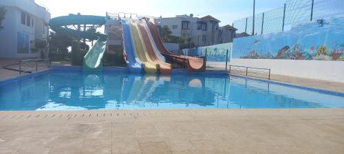 a water slide in a swimming pool at Apparemment asilah marina golf in Asilah