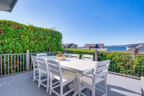 a white table and chairs on a balcony at Sun-Soaked Sandy Point Haven with Beach Access! in Langley