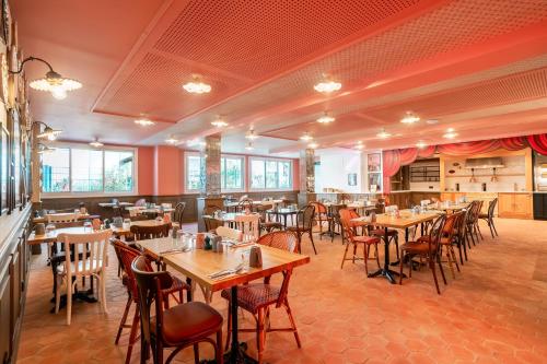 a dining room with wooden tables and chairs at RockyPop Marseille Hôtel in Marseille