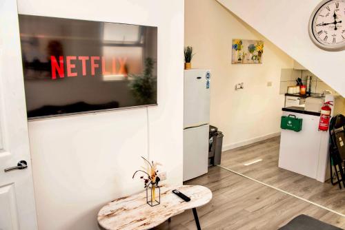 a kitchen with a refrigerator and a table in a room at 2 Bedroom Apartment Southsea - Sleeps 5 & Free Parking in Portsmouth