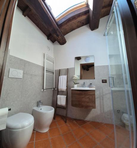 a bathroom with a toilet and a sink at Le Coppare GuestHouse in Tazzo