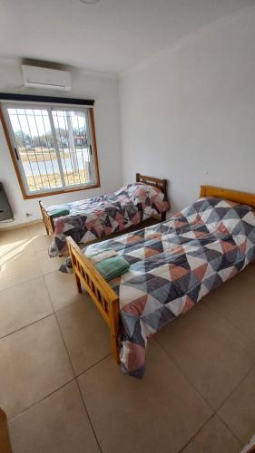 a bedroom with two beds and a window at Juanita in Toay