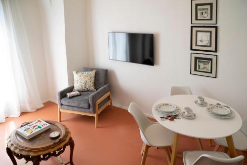 a living room with a table and a chair at Ksenio in Pyrgi