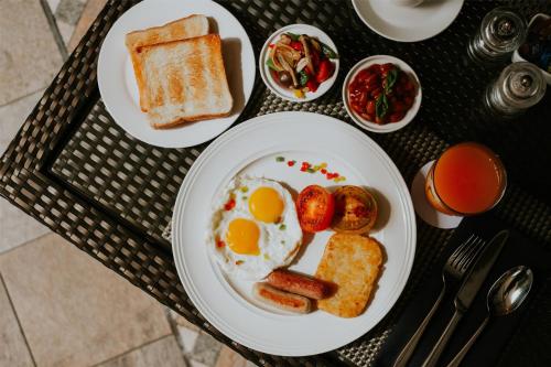 a breakfast plate with eggs and toast on a table at Radisson Hotel Brunei Darussalam in Bandar Seri Begawan
