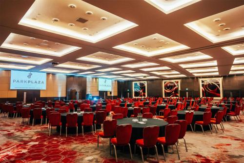 a conference room with tables and chairs and a stage at Park Plaza London Westminster Bridge in London