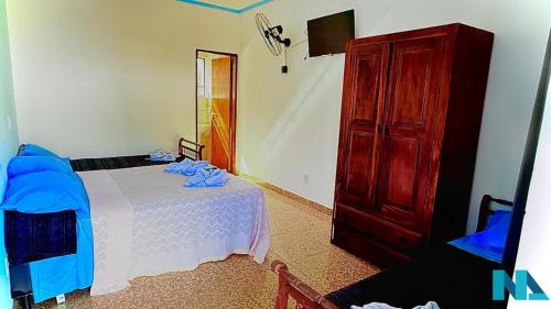 a bedroom with a bed and a dresser at Suítes por Temporada em Amparo NÃO SOMOS POUSADA in Amparo