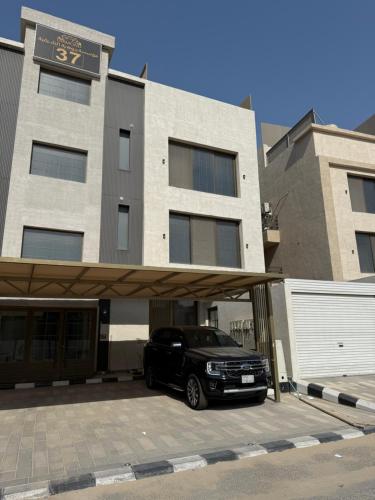 a black suv parked in front of a building at استديو الهدوء in Dammam