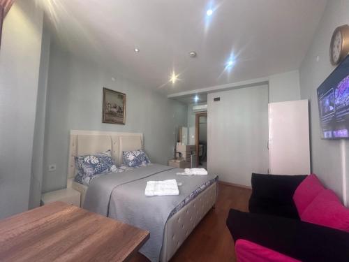 a bedroom with a bed and a couch at MYMOON Residence in Istanbul