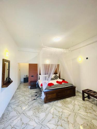 a bedroom with a bed with a mosquito net at Snuggle Cottage in Ella