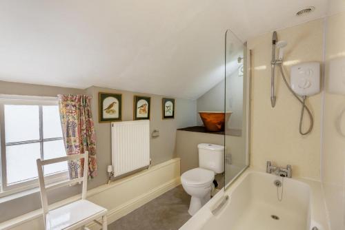 a bathroom with a toilet and a bath tub at Bellman House in Crook