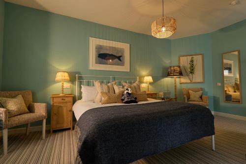 a bedroom with a bed with a teddy bear on it at Dolphin Hotel in Beer
