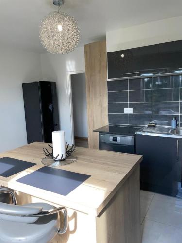 a kitchen with a counter with a sink and a stove at Chez Mégane & Anthony à Strasbourg in Entzheim