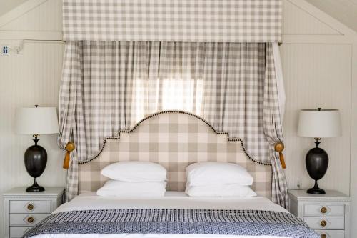 a bedroom with a bed with a checkered canopy at Hotel Lulu in Round Top