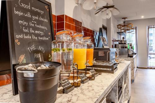 a counter with jars of orange juice on it at Holiday Inn - the niu, Pax Berlin Airport by IHG in Berlin