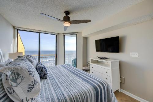 a bedroom with a bed and a ceiling fan at Charleston Oceanfront Villas 420 in Folly Beach
