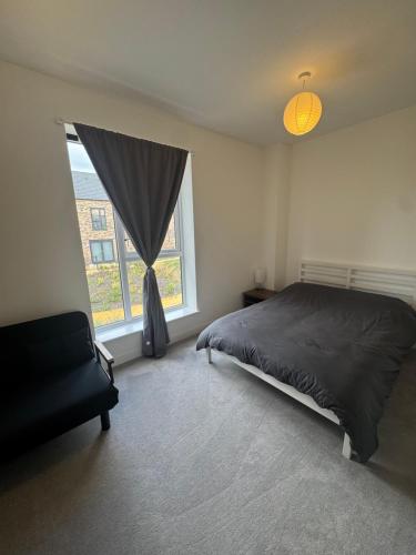 a bedroom with a bed and a large window at Blissful Abode in Birmingham