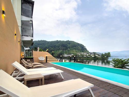 a view of a swimming pool from the balcony of a house at Interlaken Stay in Gapyeong