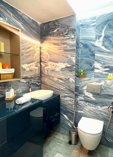 a bathroom with a sink and a toilet at Lago Welcome Limpertsberg Suite in Luxembourg