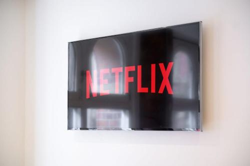 a sign that says netflix on a wall at Central Manchester Flat by City SuperHost in Manchester