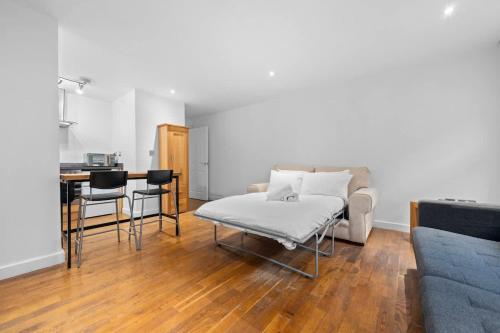 a living room with a couch and a table at Central Manchester Flat by City SuperHost in Manchester