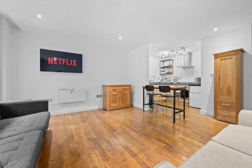 a living room with a couch and a table at Central Manchester Flat by City SuperHost in Manchester