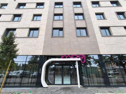 a building with a door with a pink bow on it at Moxy Verona in Verona