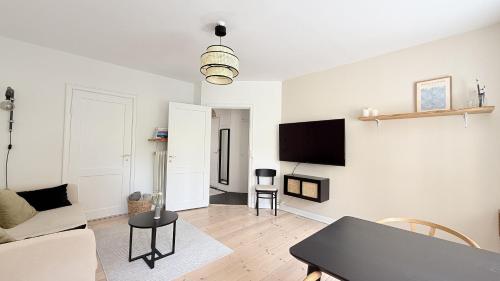 a living room with a couch and a table at ApartmentInCopenhagen Apartment 1719 in Copenhagen