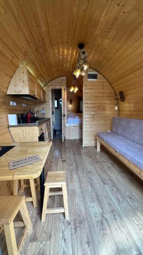 a living room with a table and a couch in a cabin at Bungalows Tea Žabljak in Žabljak