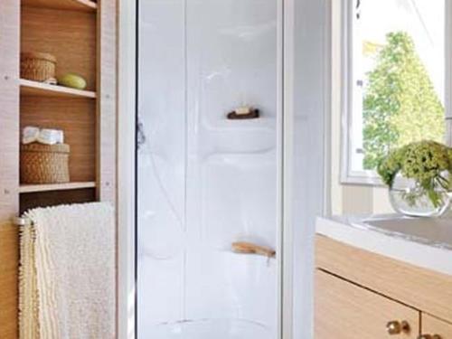 a bathroom with a shower and a sink and a window at Mobil Home Confort 2 Chambres avec Terrasse - API-1-52-347 in Rives