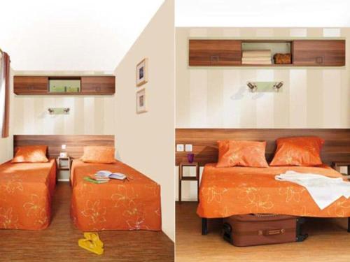 two beds in a room with orange sheets at Mobil Home Confort 2 Chambres avec Terrasse - API-1-52-347 in Rives