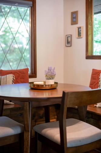 a dining room with a wooden table and chairs at Fog & Fern Hideaway at Mount Rainier in Ashford