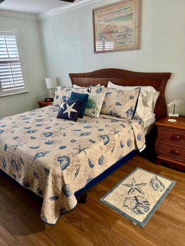 a bed with a comforter and pillows in a bedroom at Excellent beach front community, golf course, tennis, sunny weather year round! in Fort Pierce