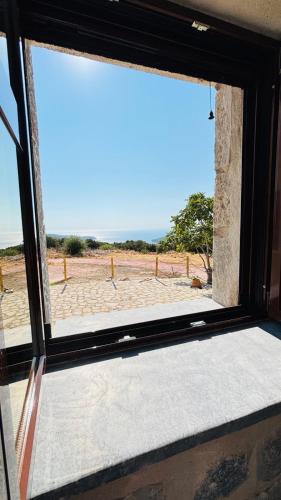 a window in a room with a view of a field at Althea Village in Areopolis