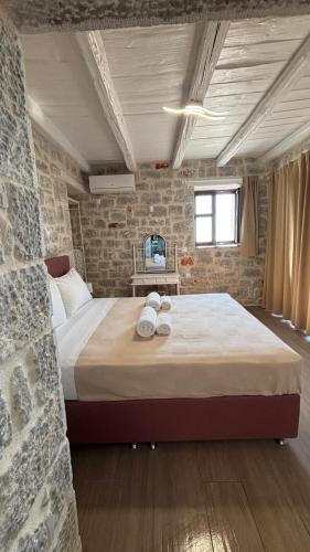 a bedroom with a large bed in a brick wall at Althea Village in Areopolis