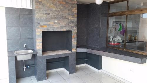 a bathroom with a sink and a fireplace at Del Este 10 in Margate