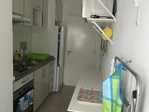 a kitchen with a sink and a table in a room at Apartamento em Palmarejo Grande in Prainha