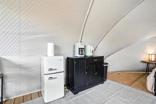 a white refrigerator in a room with a wall at Cloud Nine Tent #1 - The Ponderosa Palace in Hermosa