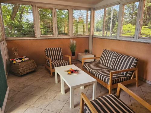 a screened in porch with two chairs and a table at Apartment 40 in Zagreb