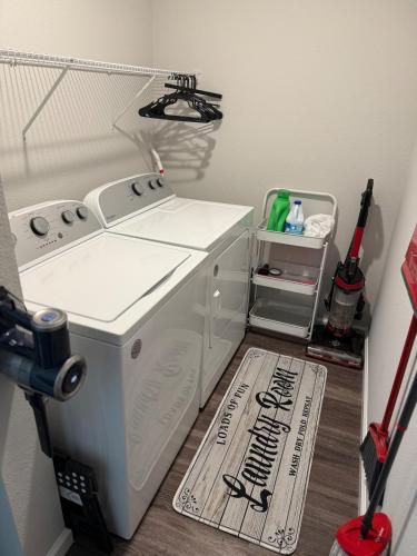 a washer and dryer in a room with a floor at The Old City Sunshine Retreat in St. Augustine