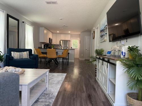 a kitchen and living room with a table and a couch at The Old City Sunshine Retreat in St. Augustine