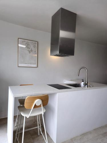a white kitchen with a sink and a counter at Interlaken Stay in Gapyeong