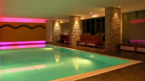 a swimming pool with lights in a house at Hotel Ochsen in Höfen an der Enz