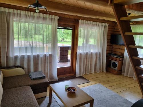 a living room with a couch and a table at Vana-Paradiisi in Uulu