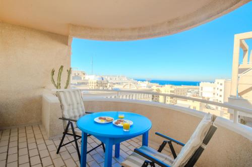 a small blue table and chairs on a balcony with a view at Garrucha Blue Horizon in Garrucha