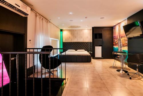 a hotel room with a bed and a balcony at Gran Motel Dubai by Drops in Caxias do Sul